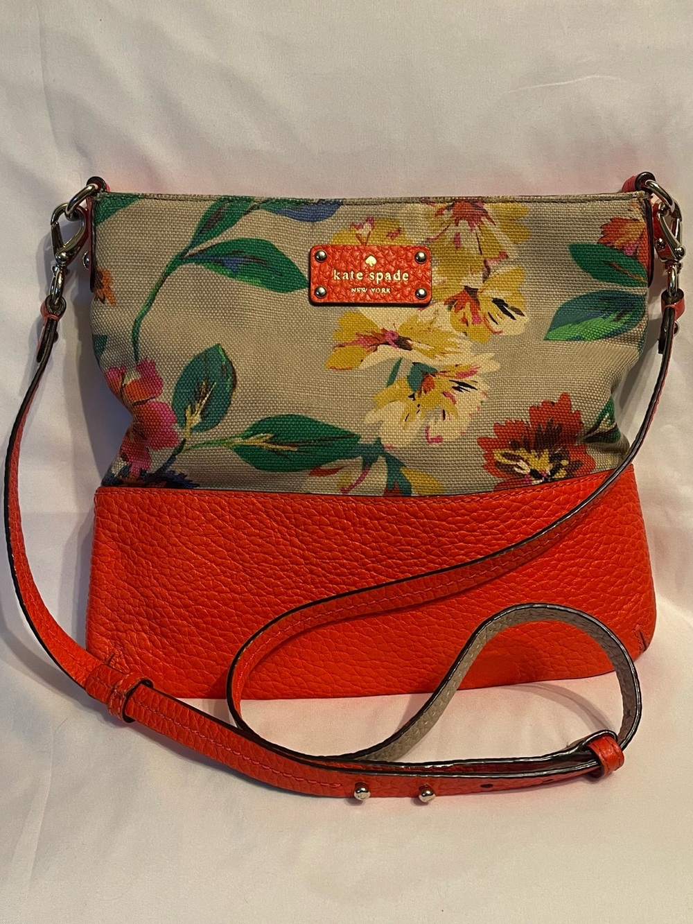 Kate Spade Grove Court floral linen and orange leather crossbody bag.
